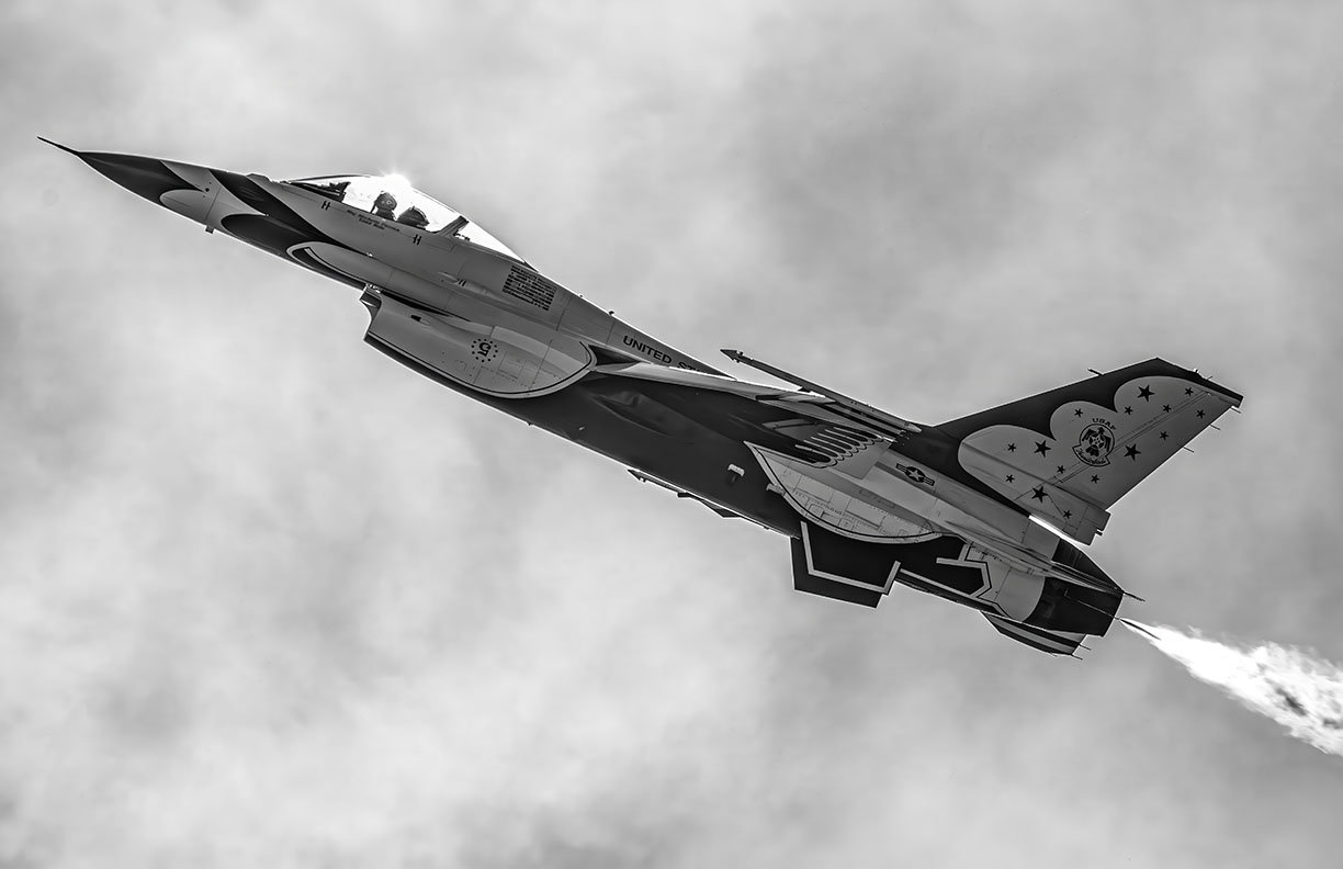 High-resolution black and white photograph of the USAF Thunderbirds F-16, flown by Maj. Michelle "MACE" Curran (Lead Solo).